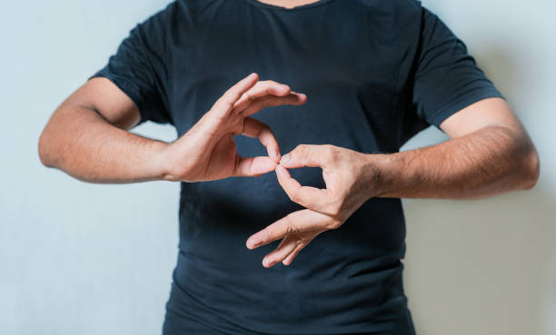 istock People speaking in sign language isolated. Young woman gesturing in sign language 2202041075