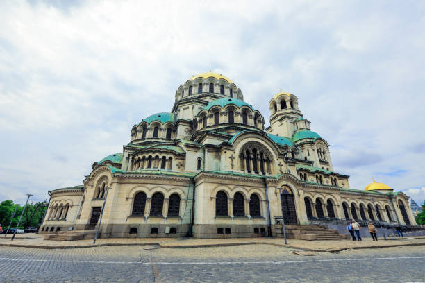 Sofia, Bulgaria - May 25, 2024: Visitors admire the impressive architecture of Alexander Nevsky Cathedral in Sofia Bulgaria on a cloudy day.