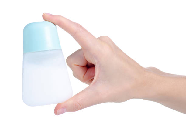 Roll-on deodorant for women in hand on white background isolation