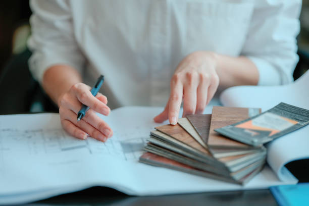 istock Asian architect engineer women read architectural information plans on blueprints in the office. 2202043383