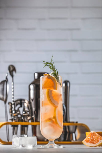 istock Refreshing pink grapefruit cocktail decorated with rosemary in elegant glass 2202044229