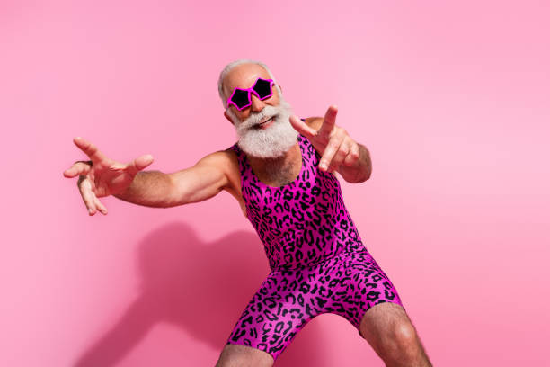 Photo of glamour senior man good mood dancing wear leopard print swimsuit isolated pink color background Photo of glamour senior man good mood dancing wear leopard print swimsuit isolated pink color background. gay man men sunglasses party stock pictures, royalty-free photos & images