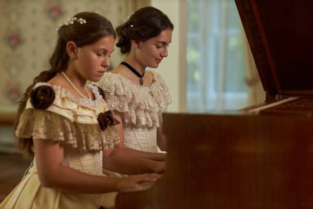 istock Two Ladies Playing Piano Duet 2202045614