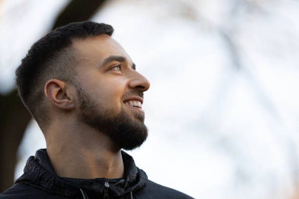 istock A young man looking at the nature around him and smiling 2202047548