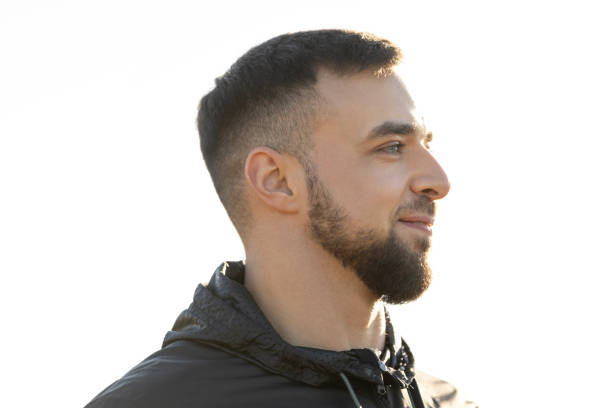 A young man looking at the nature around him and smiling