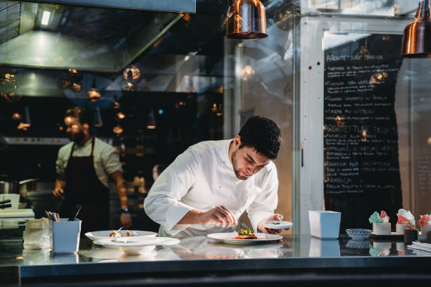 istock A chef is cooking in his restaurant's kitchen 2202051081