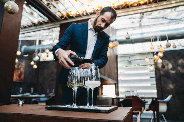 istock A waiter is pouring prosecco into glasses at the restaurant 2202051082