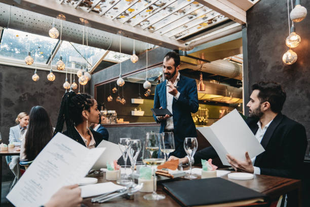 istock A waiter is taking orders in an high-end luxury restaurant 2202051253