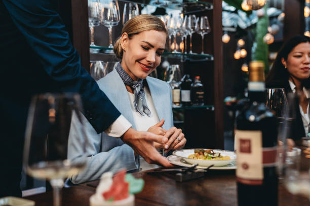 istock A waiter is serving food in an high-end restaurant 2202051262