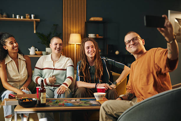 Friends Gathering and Smiling Around Board Game