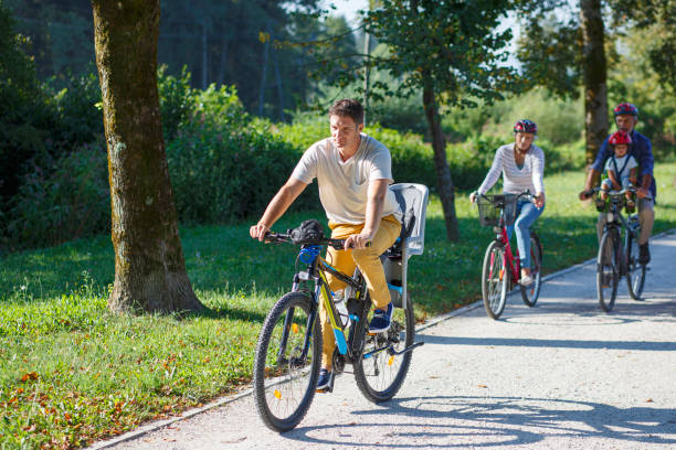 istock People cycling throuhg park 2202055515