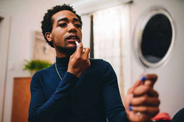 istock Non binary person is putting on makeup up in the bedroom 2202055666