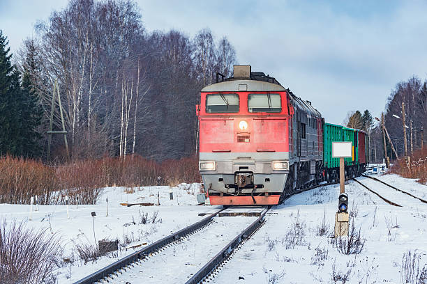 Freight train moves at winter morning.