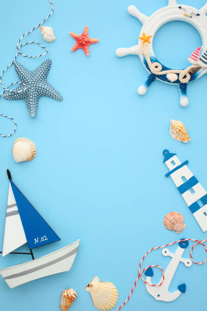 istock Nautical vertical banner design with sailboat, anchor, steering wheel, lighthouse, seashells, and starfish on light blue background, 2202060057