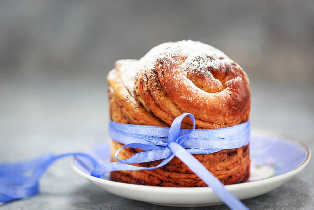 Sweet Easter bread, panettone or cruffin and colorful painted eggs, Holiday spring concept
