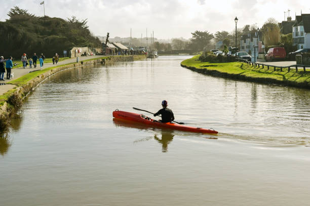 People canoeing on the Regent's canal,which is a canal across an area just north of central London.