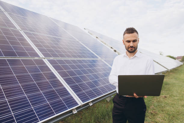 istock Male Technical engineer holding laptop. Man is doing operating and maintenance in solar power plant 2202061371