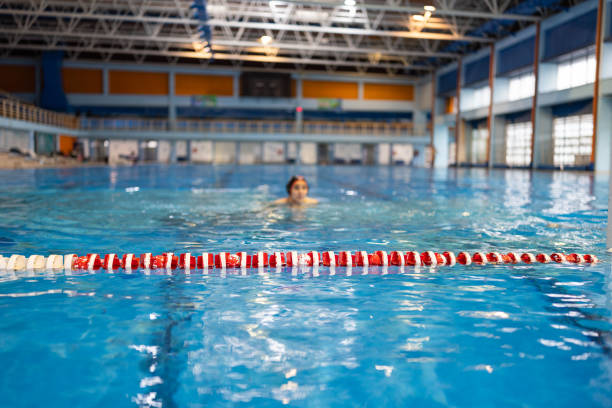 istock Young water polo player during a match in indoor swimming pool 2202061671