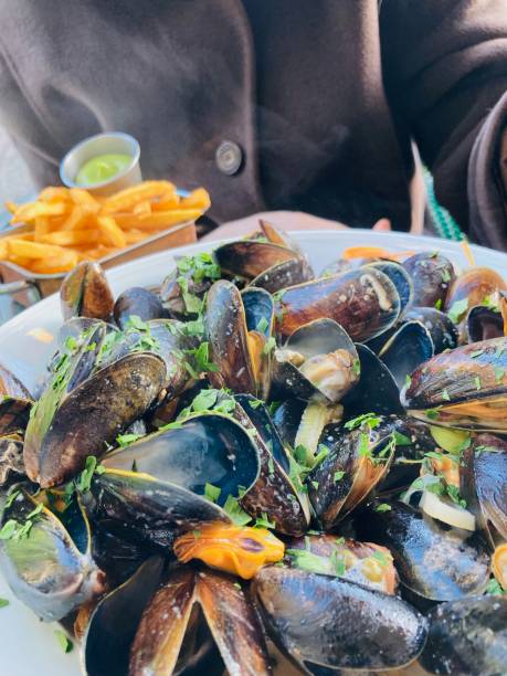 istock Eating Moules Frites on street cafe. 2202062426