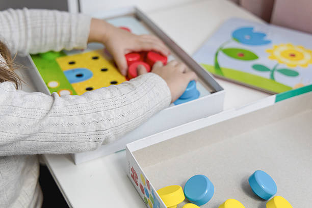 istock 2-3 years old girl playing puzzle 2202063911