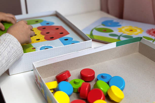 istock 2-3 years old girl playing puzzle 2202063912