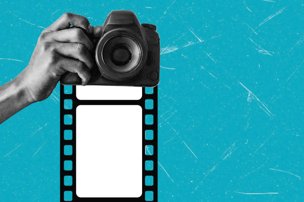 Contemporary art collage featuring hand with camera and film on blue background. Concept for a world photography day, photography world, camera for traveling.
