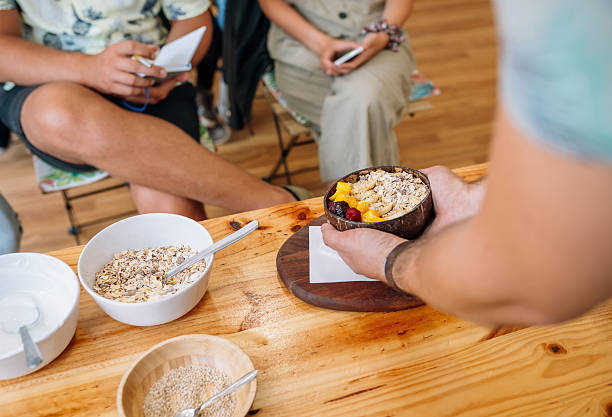istock Chef showing vegan bowl to audience taking notes in healthy cooking master class 2202068095
