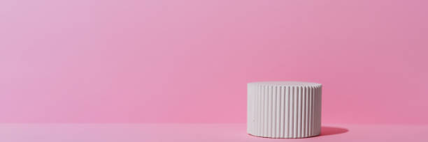 istock White podium on a pink background. Geometric premium scene for advertising and presentation your product. Showcase, display case. Banner 2202069456
