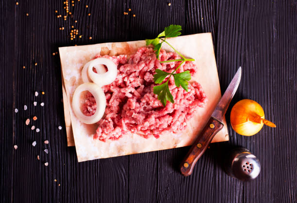 istock Fresh Raw Beef Minced Meat with salt, pepper, chilli and fresh onion 2202069603