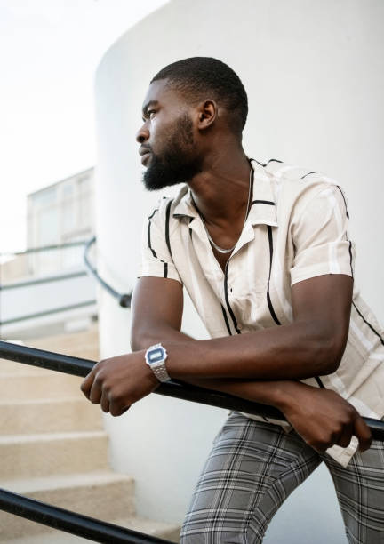 istock Bearded African man leaning on railing standing on steps outdoors 2202070138
