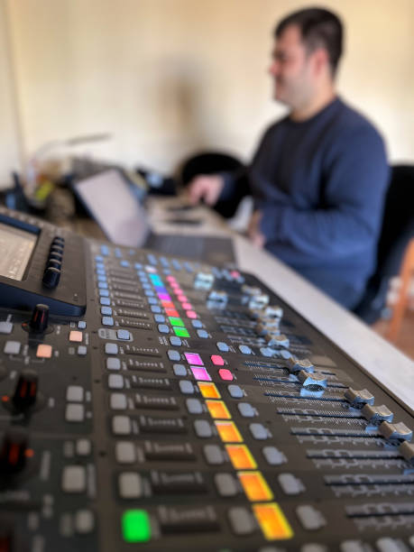 istock Sound technician at work sitting in front of the sound mixing table 2202070294