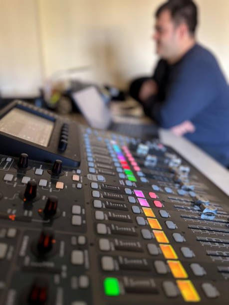 Sound technician at work sitting in front of the sound mixing table