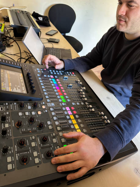 istock Sound technician at work sitting in front of the sound mixing table 2202070361