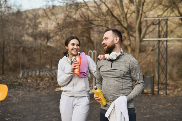 istock Joyful Couple Talking and Smiling After Morning Workout Session 2202074008