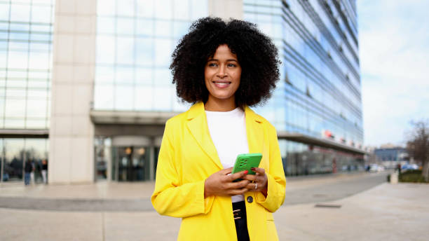 istock Happy woman enjoying her walk and using smartphone 2202075025