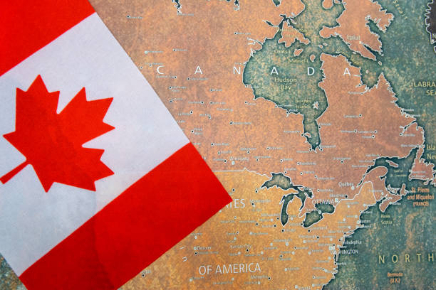 istock Canada national flag on the paper world map. 2202076149
