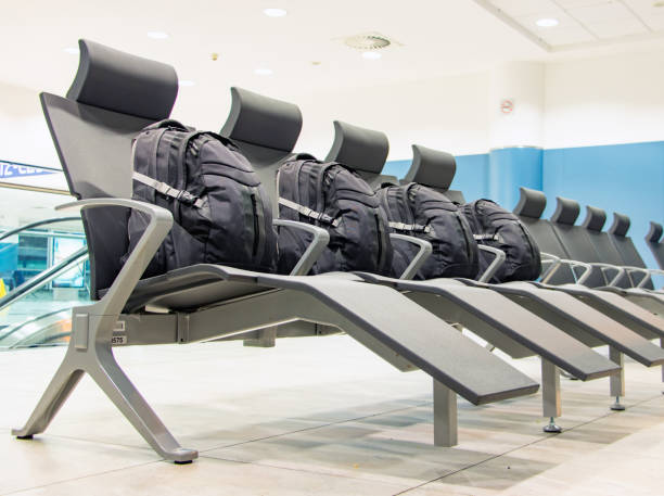 istock A group of an identical backpacks laid in seats in an empty hall 2202076575