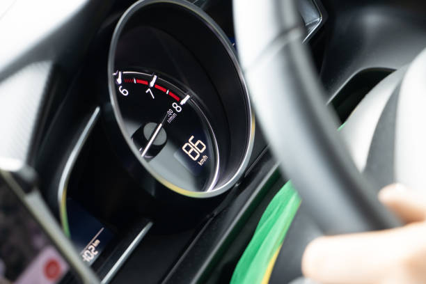 A view of a speedometer in a moving car, close up.