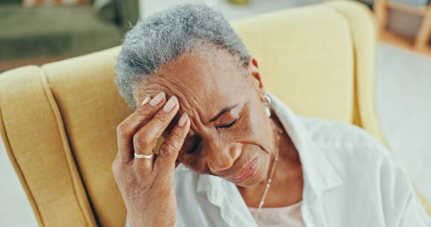 istock Sad, senior and thinking with black woman on sofa for reflection, depression and retirement. Dementia, memory and regret with elderly person in living room of nursing home for grief, lonely and tired 2202077128