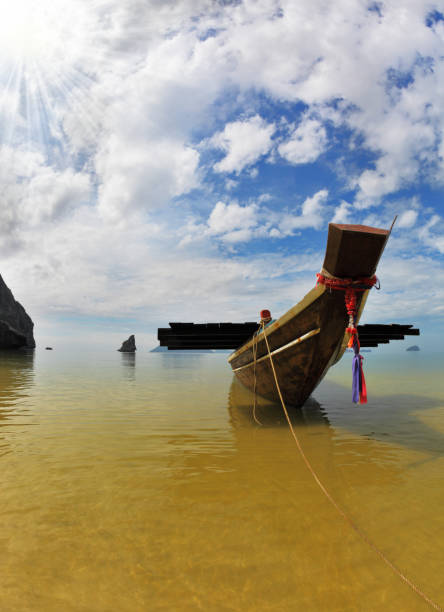 The famous Thai Longtail boat mooring anchor in the sand. The picturesque sandy beach on an ocean island. Thailand