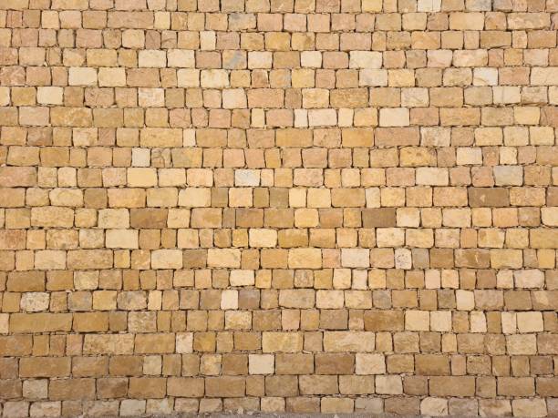 A stone wall with a white border is shown. The border is made of a different type of stone than the wall itself, giving it a contrasting appearance