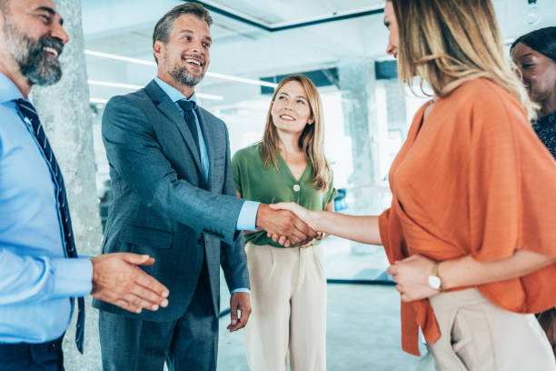 istock Business people shaking hands in the office 2202088578