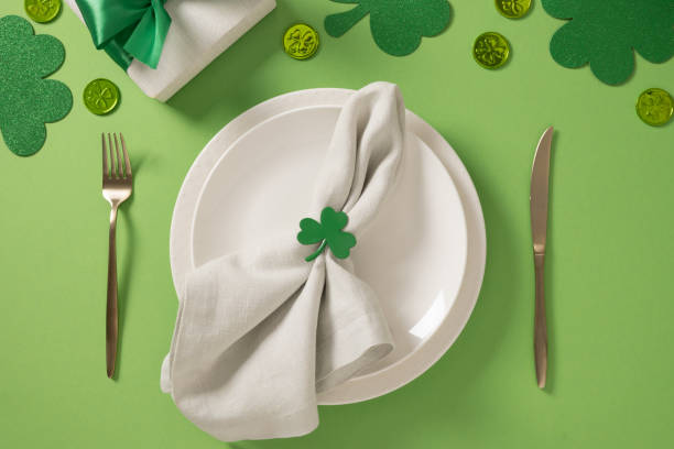 istock St Patrick's Day party table setting with green decoration on background. 2202089864