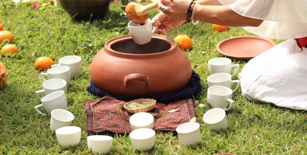 istock Cups being filled with organic chocolate from earthenware jars in a holistic session. 2202090251
