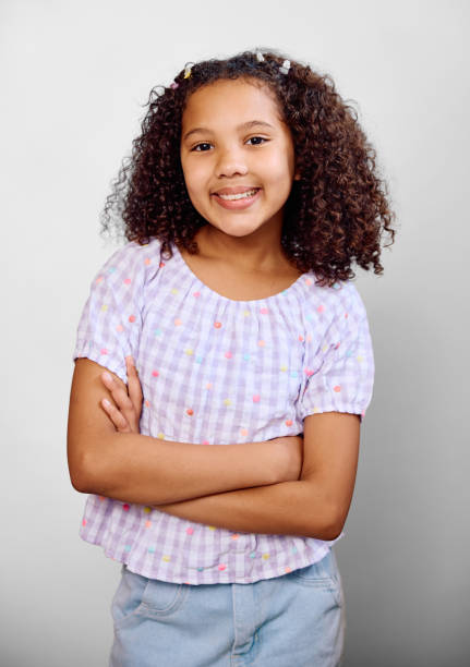 istock Studio portrait of girl wearing gingham blouse, arms folded 2202091299