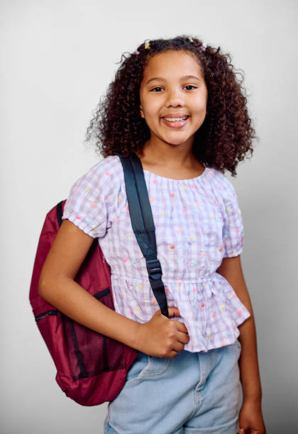 istock Studio portrait of girl wearing gingham blouse carrying backpack 2202091331