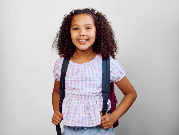 istock Studio portrait of girl carrying backpack wearing gingham blouse 2202091347