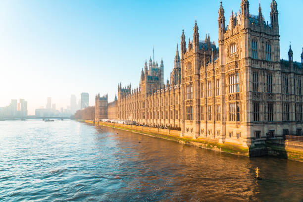 istock Palace of westminster reflecting on the thames river at sunset 2202091727