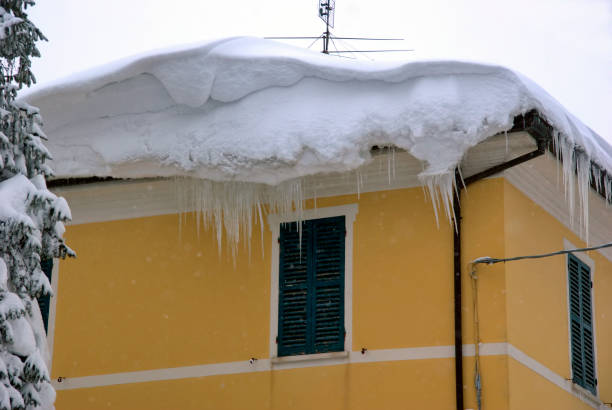 snow cornices on a roof after a blizzard