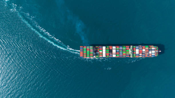 istock Top view Logistics and transportation of Container Cargo ship and Cargo plane with working crane bridge in shipyard at sunrise, logistic import export and transport industry background 2202093824